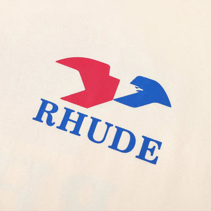 Cream T-shirt chest graphic with red and blue Rhude logo