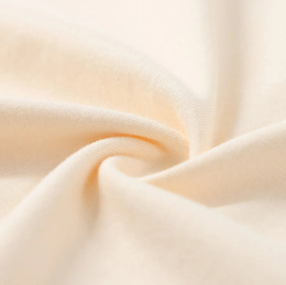 Cream T-shirt sleeve fabric close-up with soft knit texture