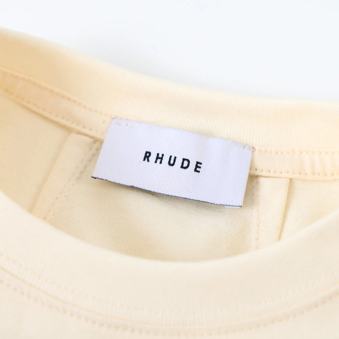 Beige T-shirt neckline with interior neck label and RHUDE print