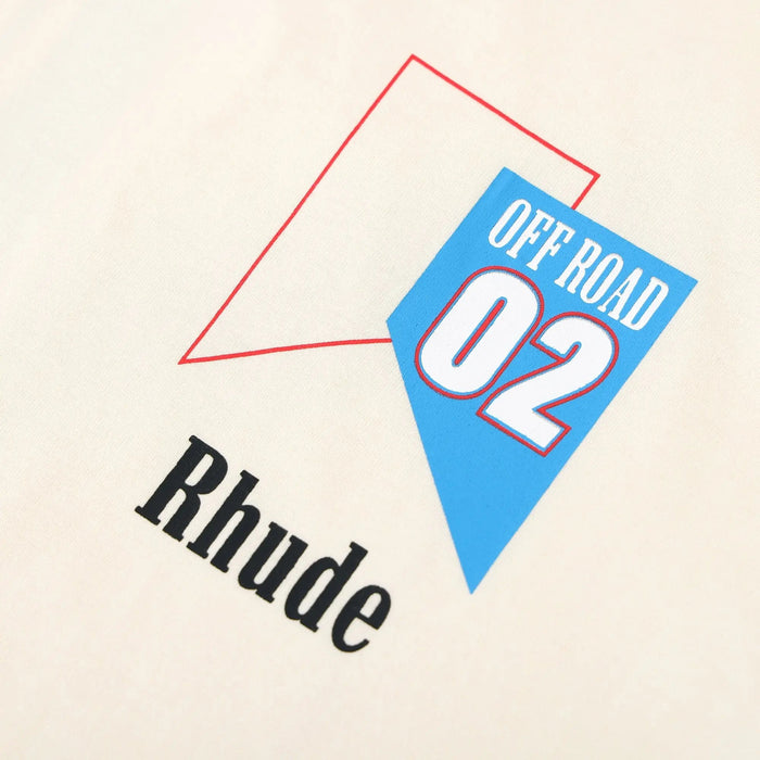 Beige T-shirt graphic detail with blue Off Road 02 and black Rhude text