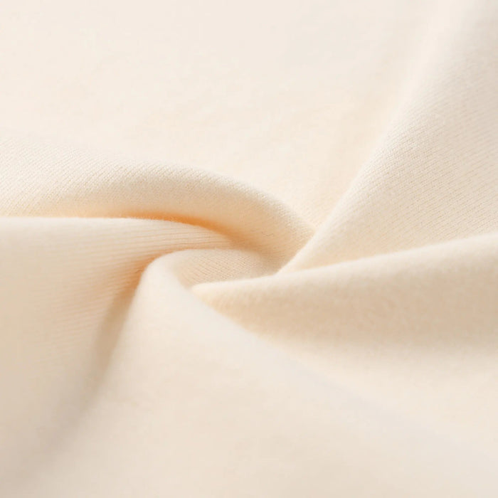 Beige cotton T-shirt fabric texture close-up
