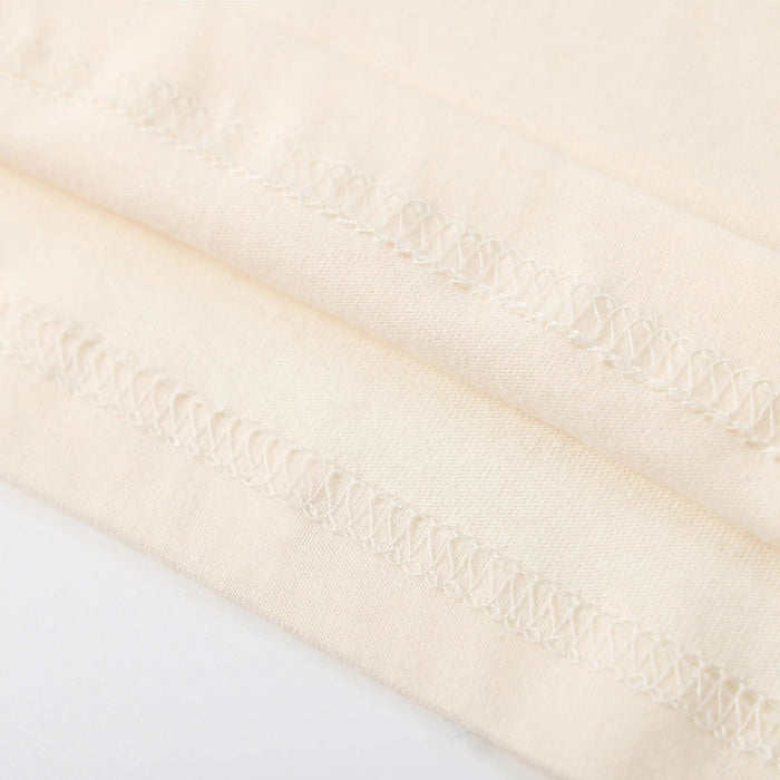 Beige T-shirt hem stitching detail