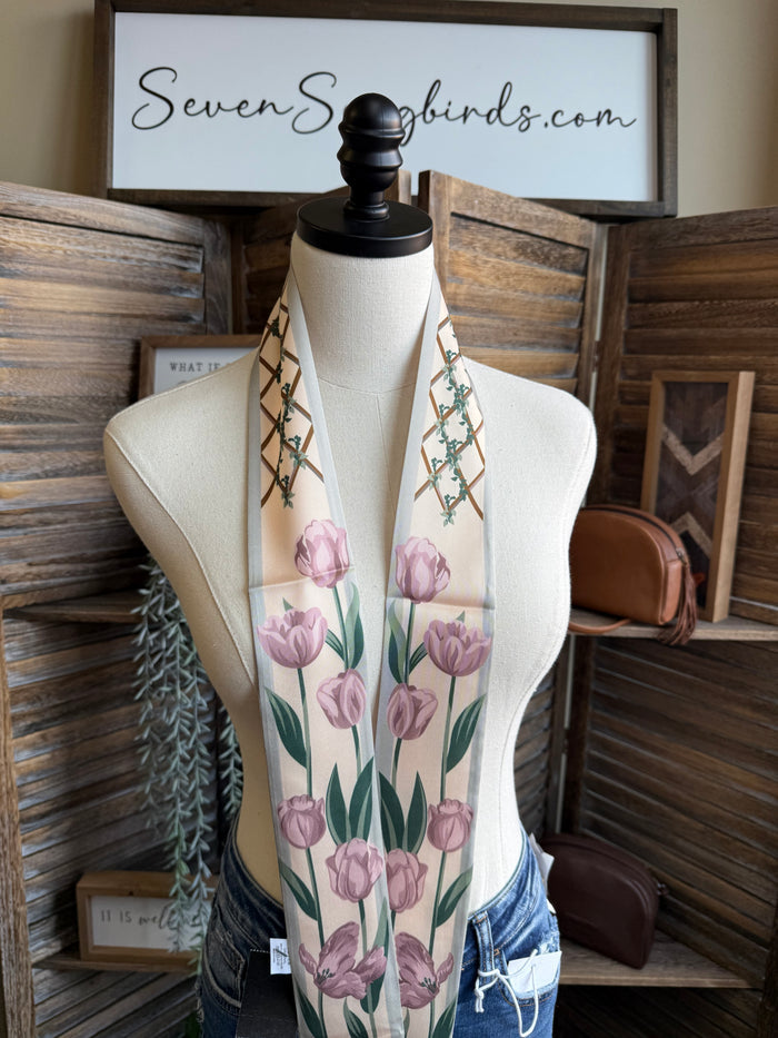 Rose floral twilly scarf with pink rose print and green vine border, on mannequin
