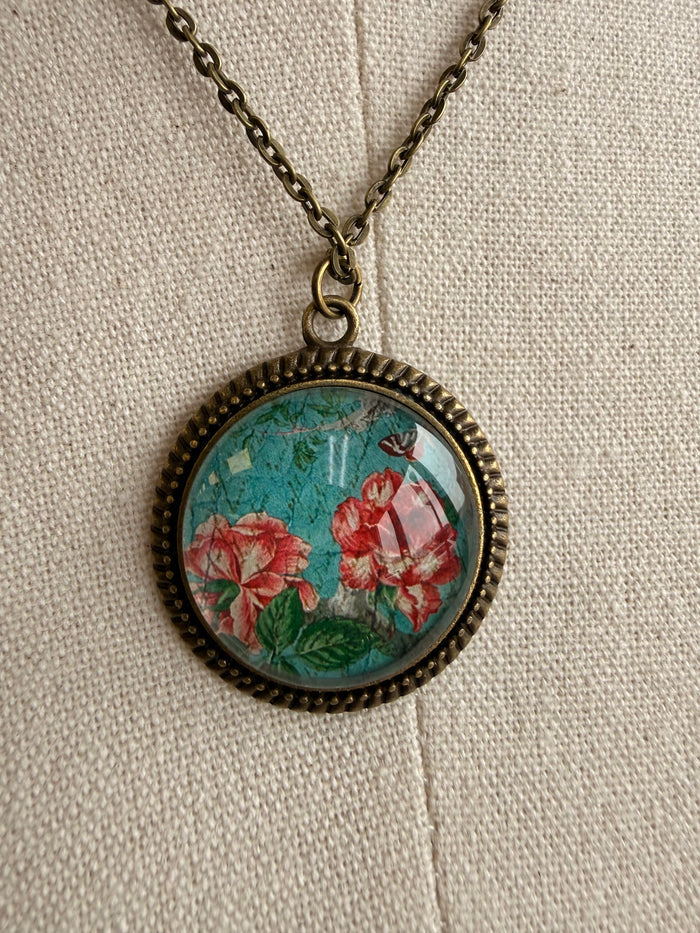 Round rose glass pendant with ornate gold bezel and red rose floral design