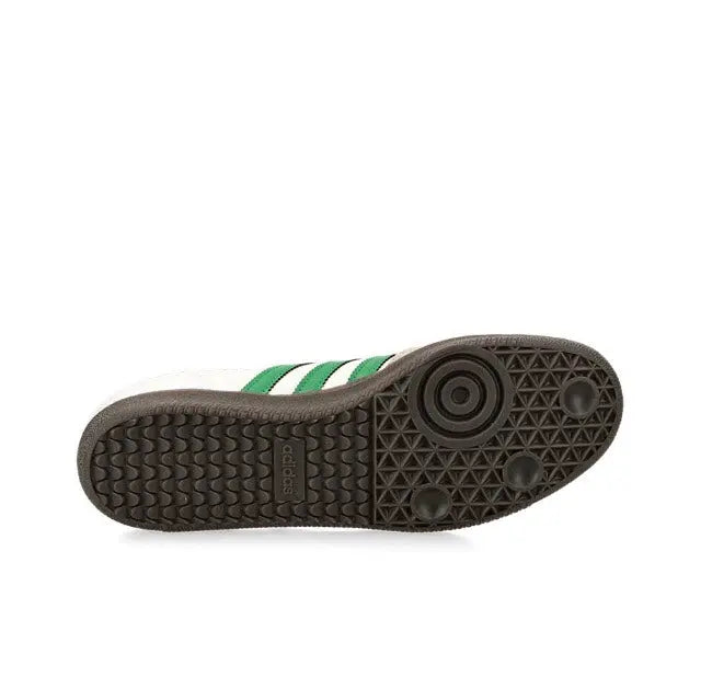 Low-top sneaker outsole with textured tread and green stripe sidewall