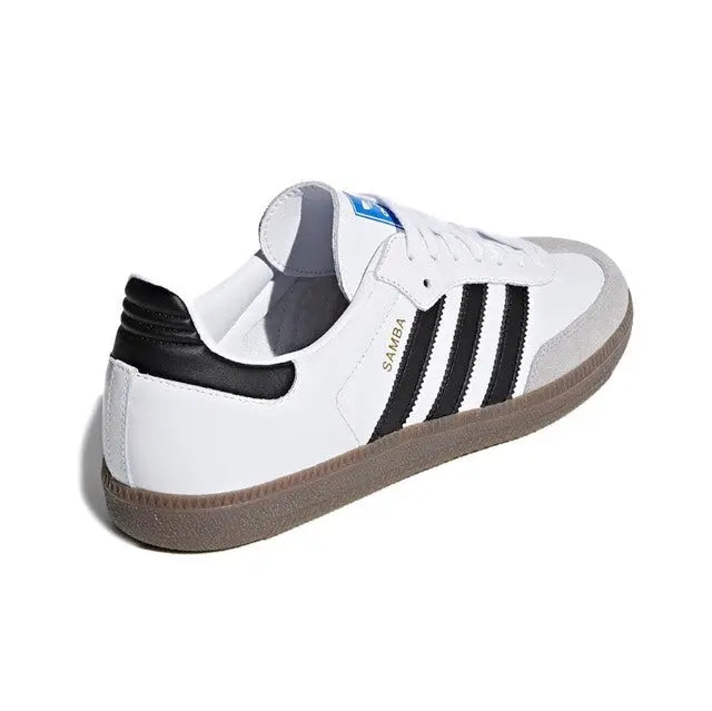 Low-top sneakers with white uppers, black heel detail, and three black stripe panels