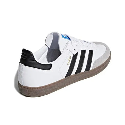 Low-top sneakers with white uppers, black heel detail, and three black stripe panels