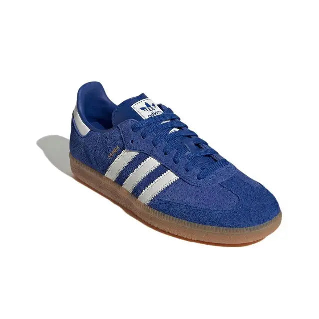 Blue suede sneakers with white triple stripes, lace-up, gum-brown sole