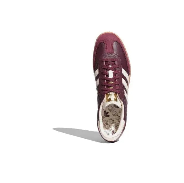 Adidas Samba OG sneaker front view, maroon lace-up upper with white stripes