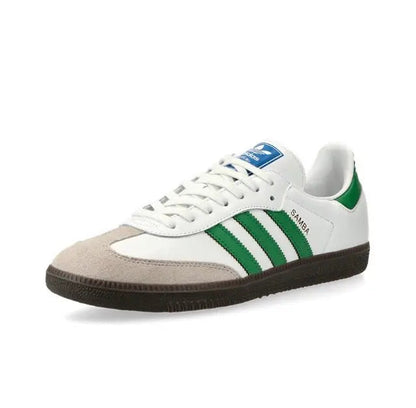Low-top sneakers with white leather, green three stripes, and brown rubber sole