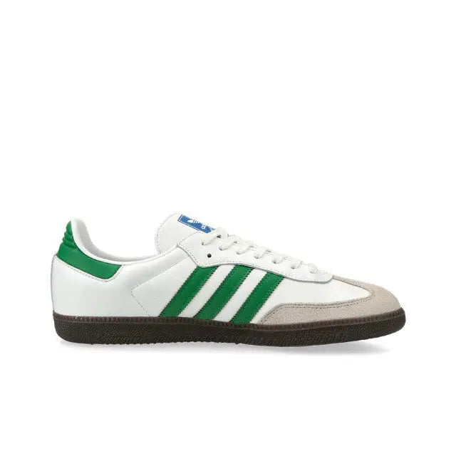 Low-top sneakers side view in white with green stripes and dark gum sole