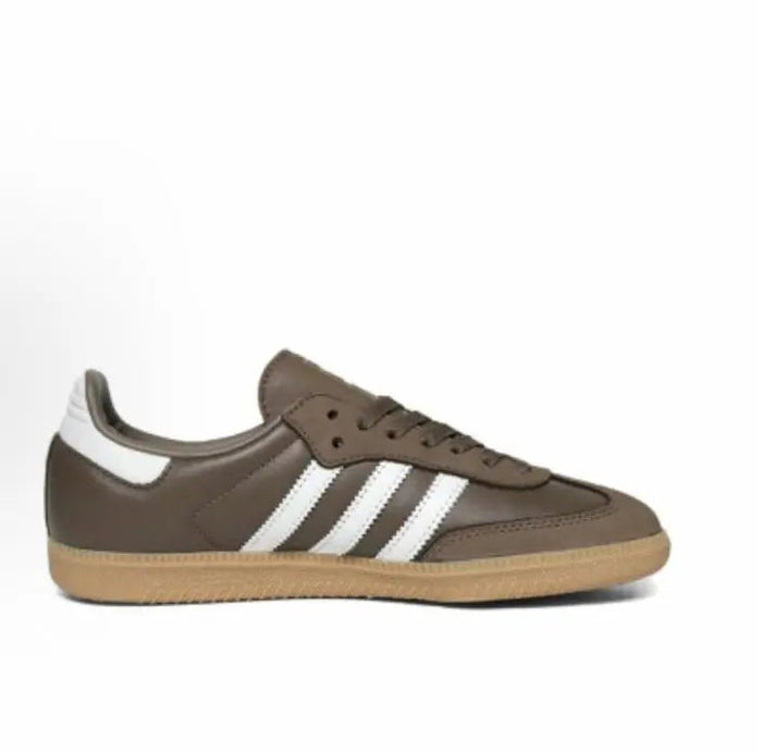 Brown low-top Samba sneakers with white stripes and lace-up closure