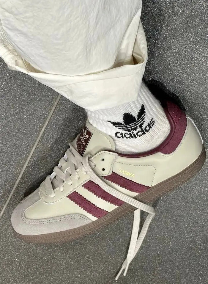 Adidas Samba OG sneakers on wearer, cream leather with burgundy stripes and white laces