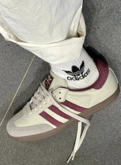 Adidas Samba OG sneakers on wearer, cream leather with burgundy stripes and white laces