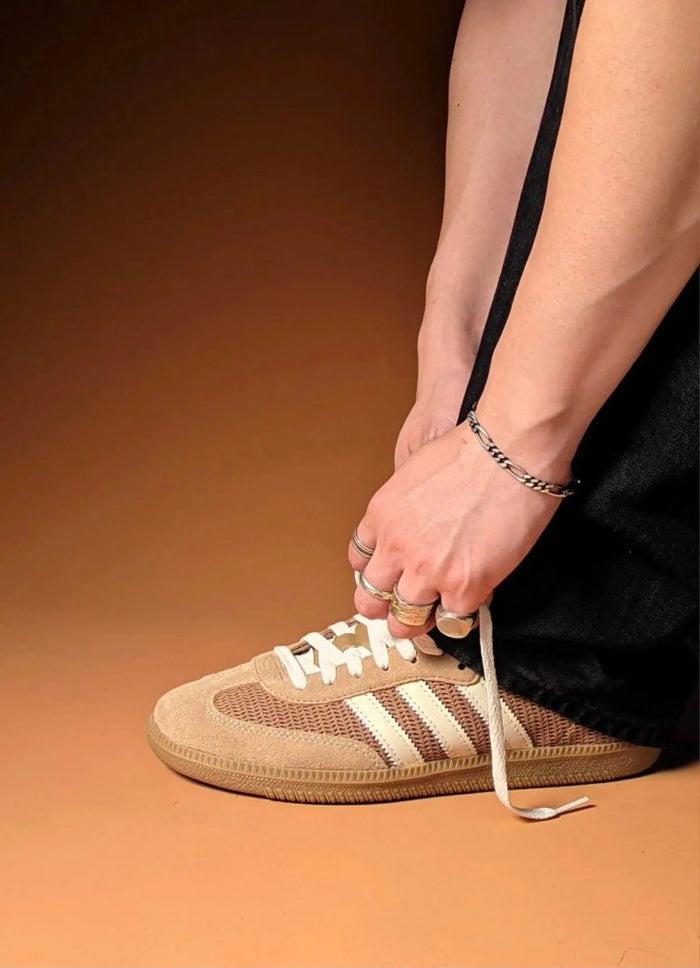Samba OG sneaker on foot, brown upper with white stripes and white laces