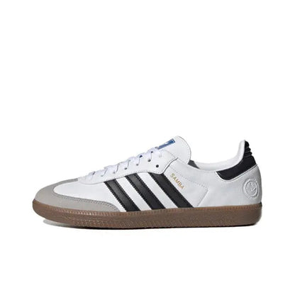 White, black, and gum Adidas Samba vegan sneakers with suede-like stripes and laces.