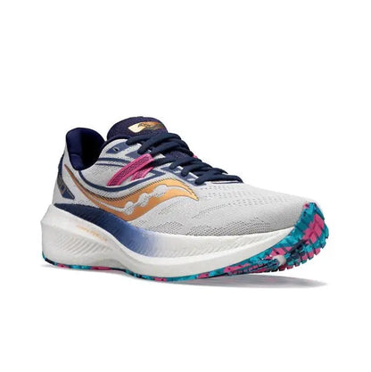 Light gray running shoe, navy tongue and heel, gold swoosh, pink strap, blue speckled sole