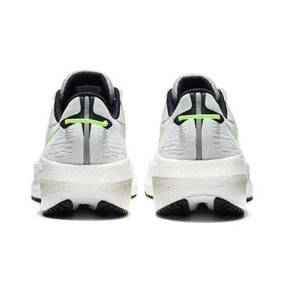 Saucony Triumph 21 running shoes back view, white with neon green stripes and black heel