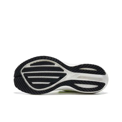Saucony Triumph 21 running shoe outsole, black tread with white midsole and neon green detail