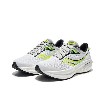 Saucony Triumph 21 running shoes front view, white knit upper with neon green accents