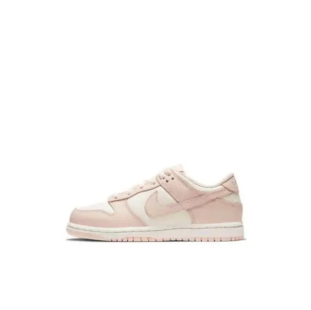 Light pink Nike SB Dunk Low low-top sneakers with white swoosh and pink laces.