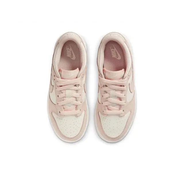 Light pink lace-up low-top sneakers with white midsoles; top view of both shoes.