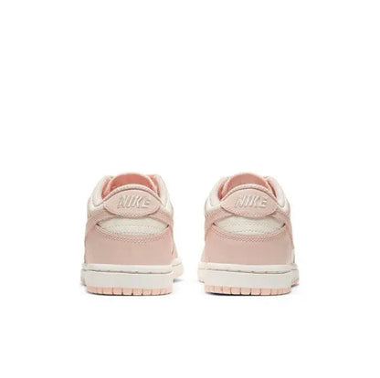 Light pink Nike SB Dunk Low sneakers from the heel and back; visible heel branding.