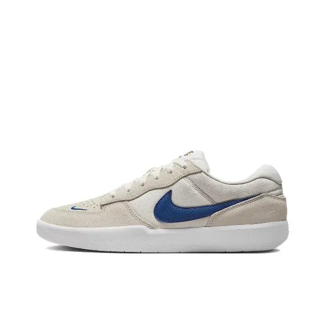 Low-top skate shoes, cream canvas with blue Swoosh and white rubber sole.