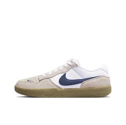 Low-top sneaker in white and beige with navy swoosh and gum rubber sole