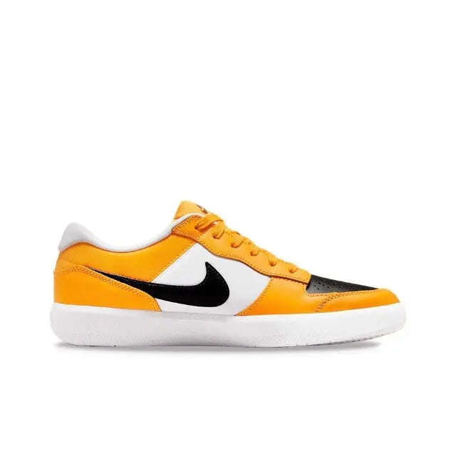 Low-top sneakers in orange and black with white paneling and Swoosh logo