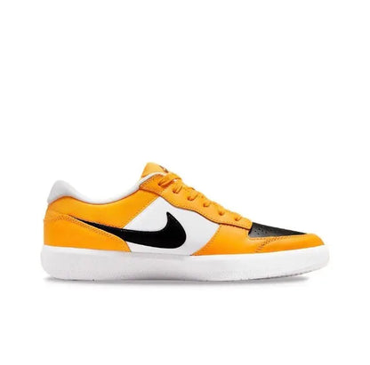Low-top sneakers in orange and black with white paneling and Swoosh logo