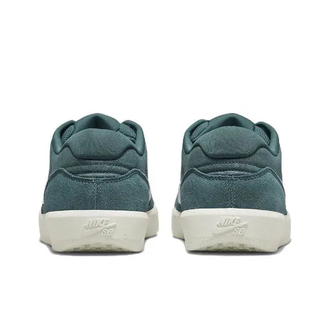 Green low-top sneakers, rear view with padded collar and white outsole