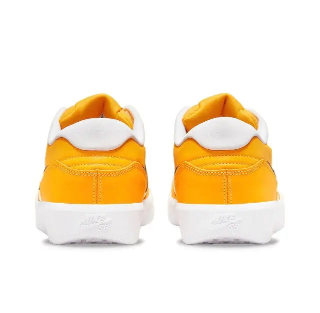Pair of orange low-top sneakers with white heel tab and cushioned collar
