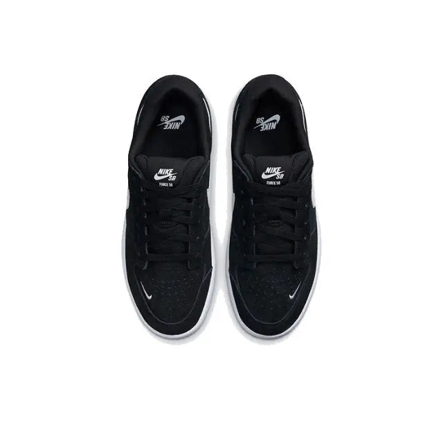 Black low-top skate shoes with lace-up front and Swoosh on tongue