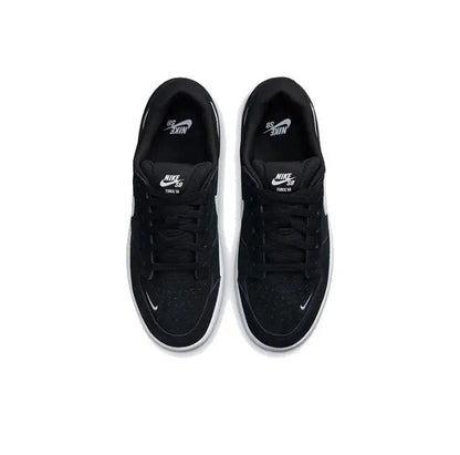 Black low-top skate shoes with lace-up front and Swoosh on tongue