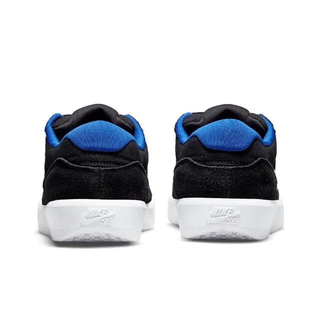 Pair of black skate sneakers with blue collar lining and white heel label