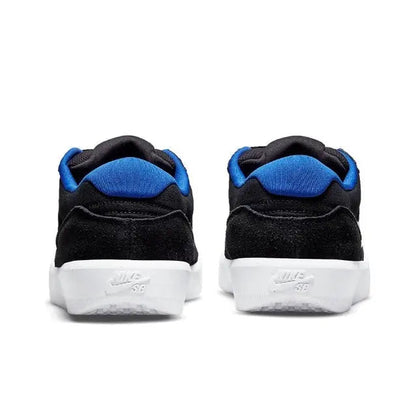 Pair of black skate sneakers with blue collar lining and white heel label