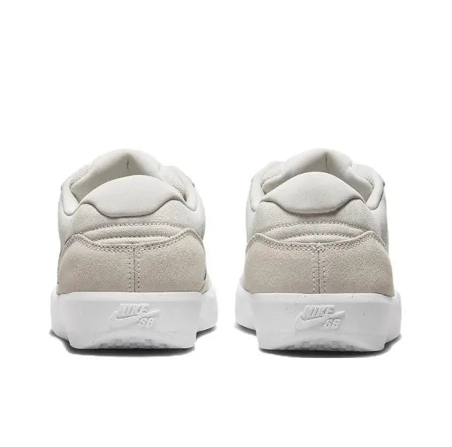 Low-top skate shoes heel view, cream upper with padded collar and white midsole.