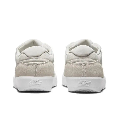 Low-top skate shoes heel view, cream upper with padded collar and white midsole.