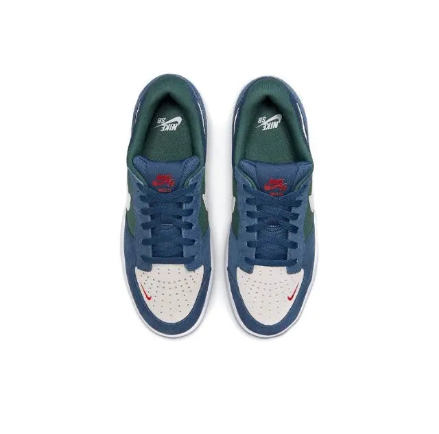 Navy low-top skate shoes with green insoles, white panels, and red logo