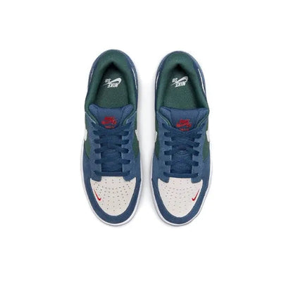 Navy low-top skate shoes with green insoles, white panels, and red logo