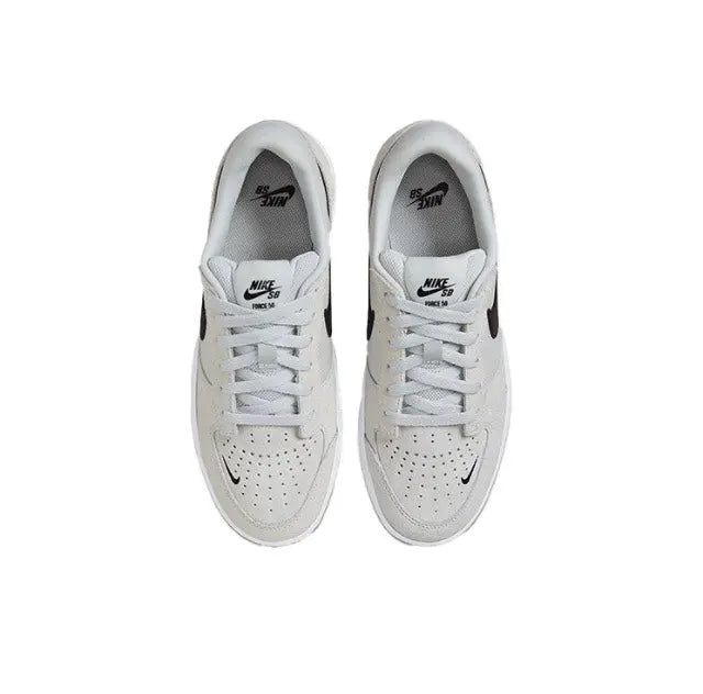 White laced Nike SB sneaker with perforated toe and black side swoosh