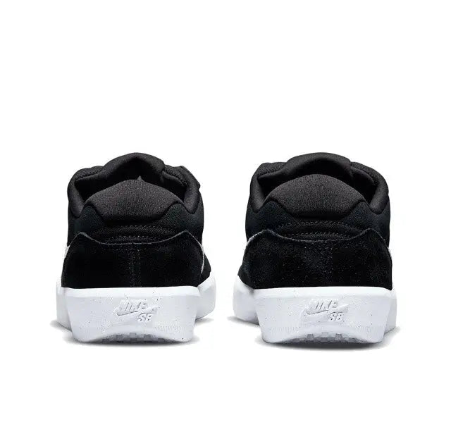 Black low-top skate shoes heel view with white midsole branding