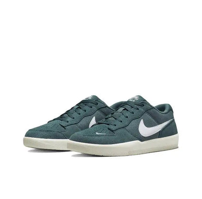 Green low-top sneakers with two shoes, white Nike swoosh and white sole