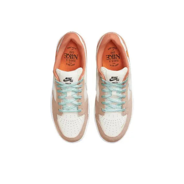 Pair of Nike SB low-top sneakers with cream perforated toe, mint laces, rust lining.