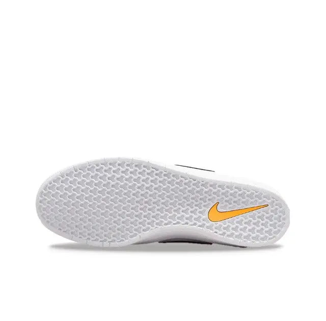 White rubber outsole with textured tread and orange Nike Swoosh detail