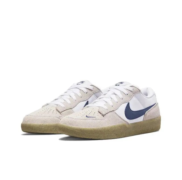 Pair of low-top sneakers in white and beige with navy swoosh and gum sole