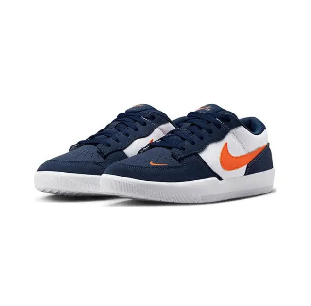 Navy low-top skate shoes with white panels, orange swoosh, and white rubber sole