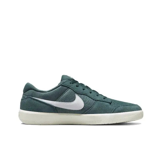 Green low-top sneakers with white Nike swoosh, lace-up design and padded collar
