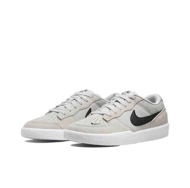 Light grey low-top skate shoe with black swoosh and white midsole